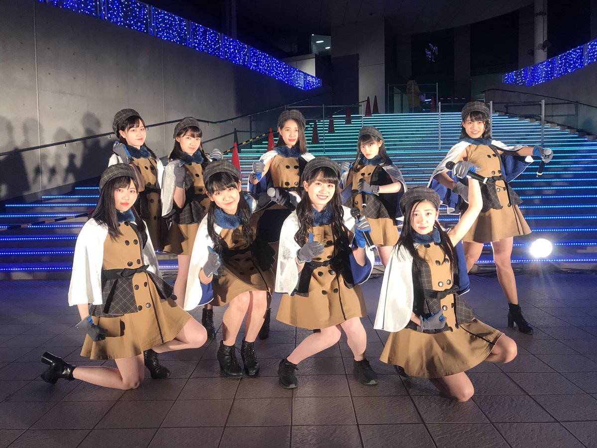 tsubaki factory posing together outside at night wearing their outfits for teion yakedo